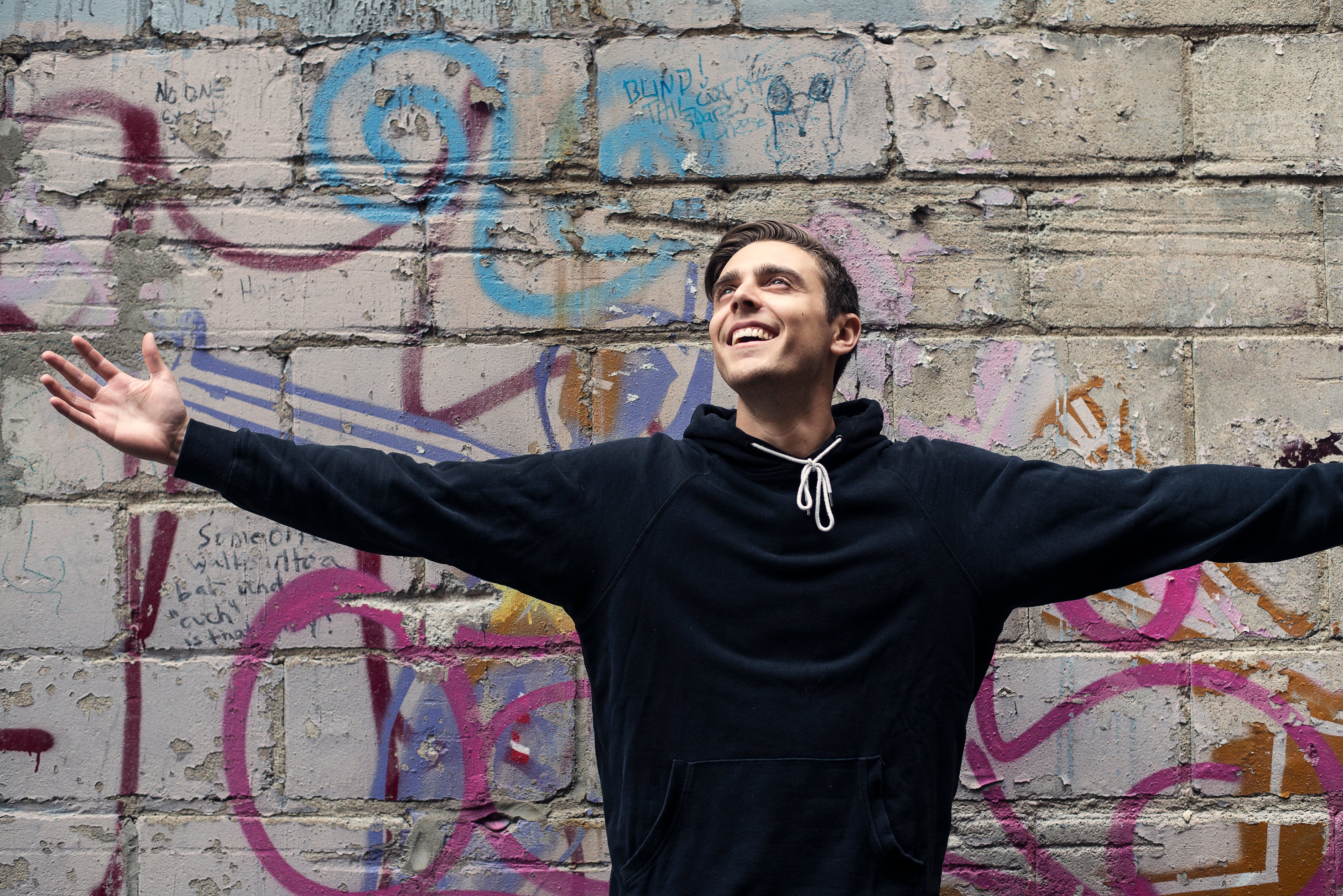 files/man-smiles-with-open-arms-in-city.jpg